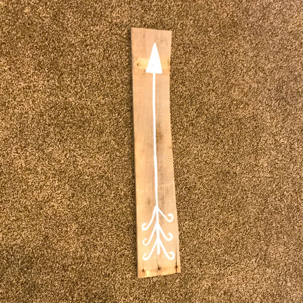 Wooden sign with white arrow